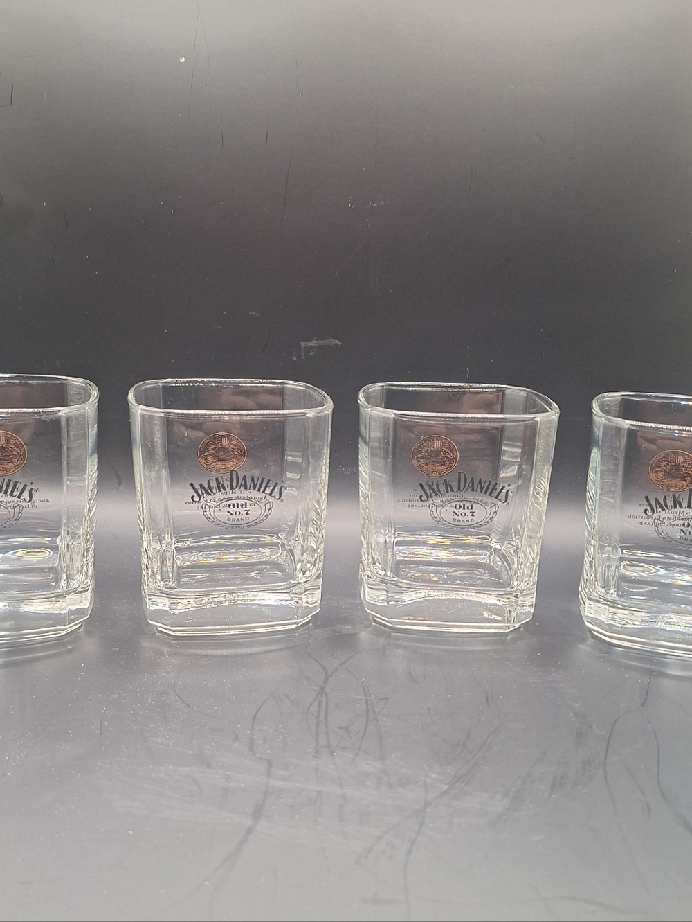 The product is a set of 4 Jack Daniel’s 1905 Gold Medal Square 10 oz whiskey